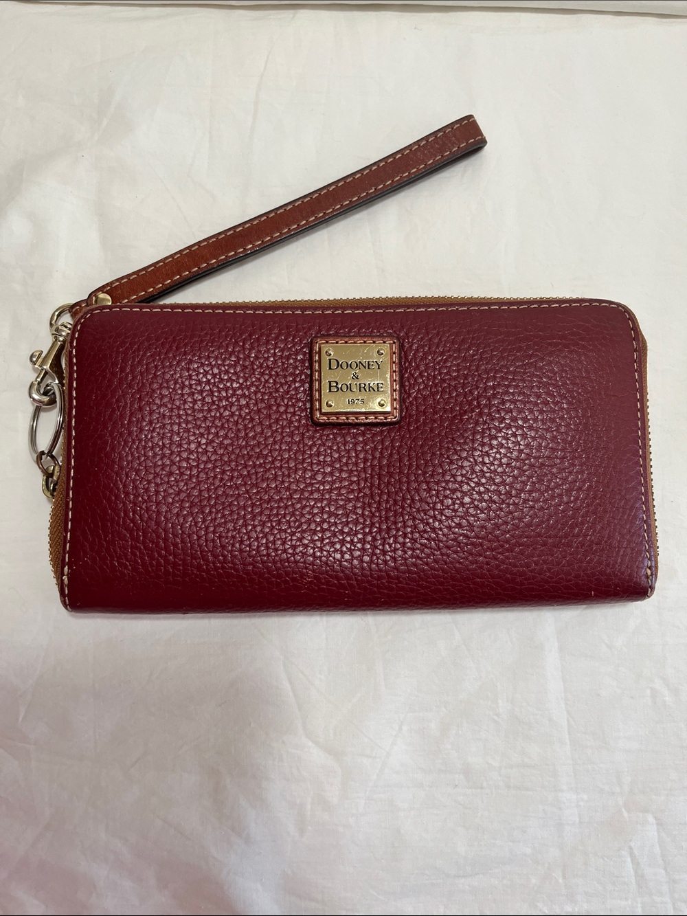 Dooney & Bourke Pebbled Leather Wristlet in Burgundy with Tan Strap